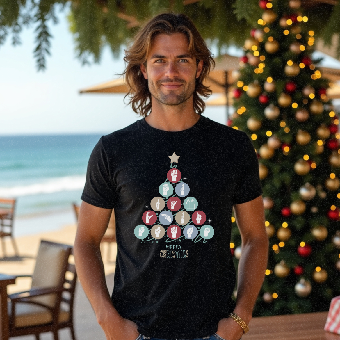 Male surfer in his 20s in a black Christmas t-shirt with 'Merry Christmas' spelled out in ASL in the shape of a Christmas tree by Faith Looks Good