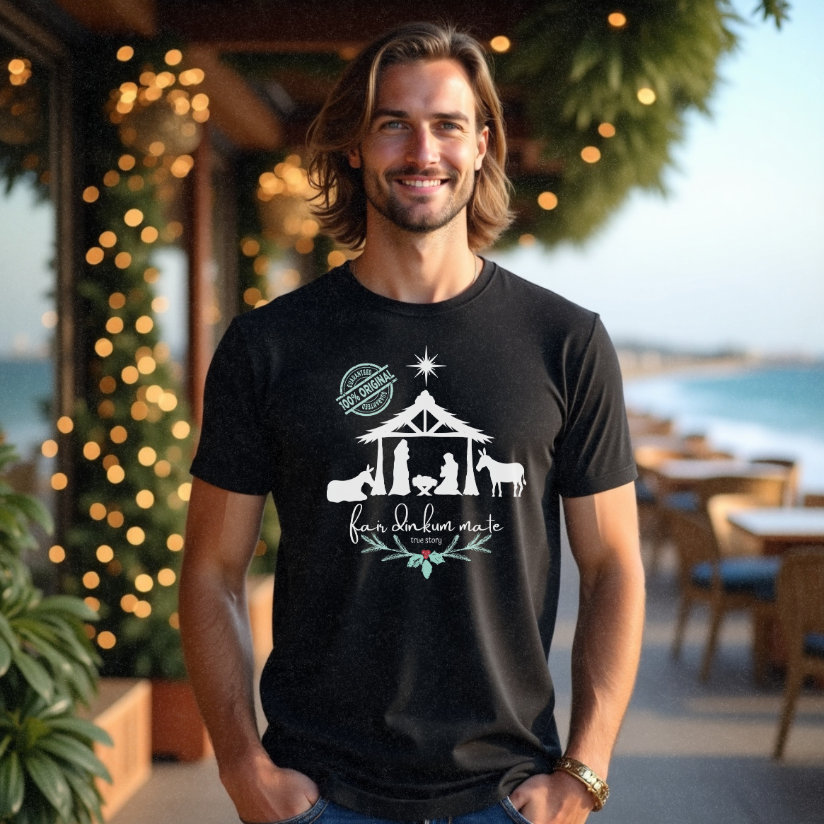 Male standing in a cafe near the water wearing a funny black Christmas t-shirt with a nativity scene and message 'Fair Dinkum Mate True Story' by Faith Looks Good